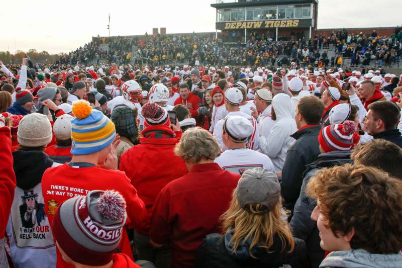 a large crowd of people in white and red outfits