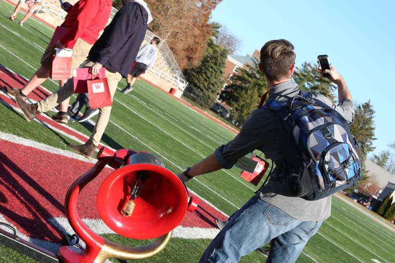 a man taking a picture of a horn on a football field