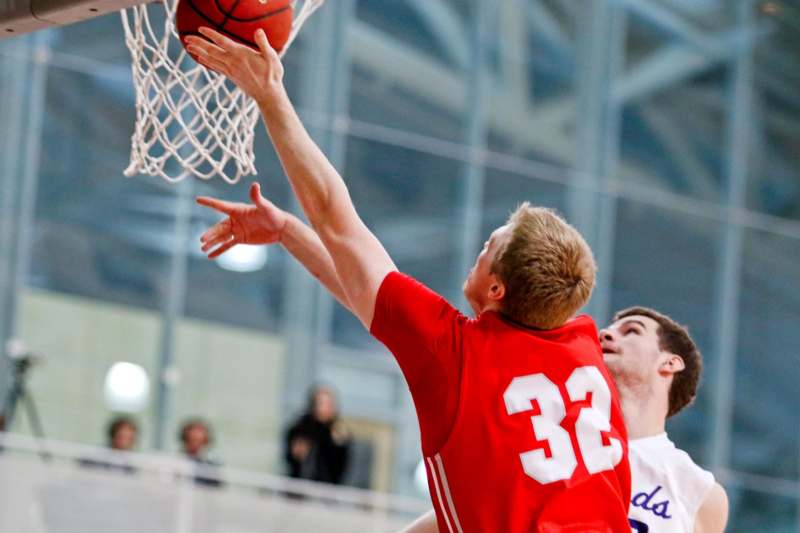 a man in a red jersey playing basketball