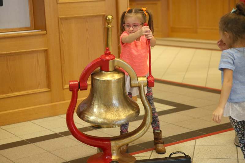 a girl holding a bell