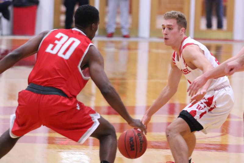 a basketball player in red and white uniform dribbling a basketball