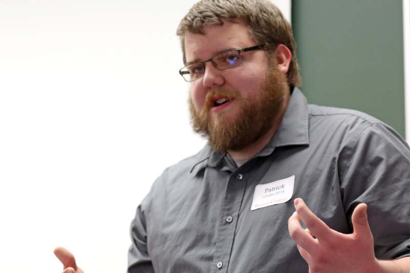 a man with a beard wearing a name tag
