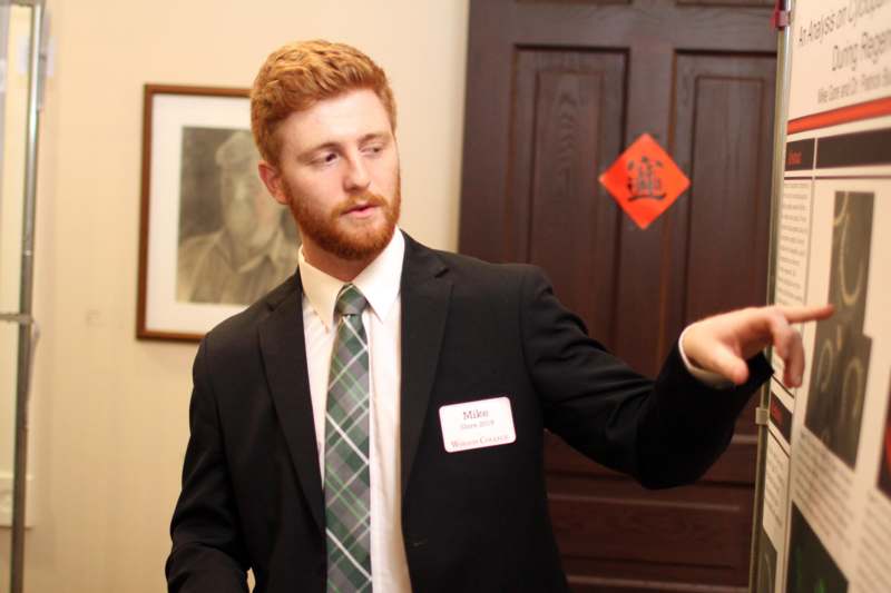 a man in a suit pointing at something