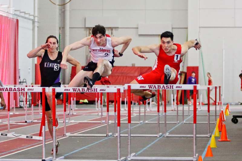 a group of people running over hurdles