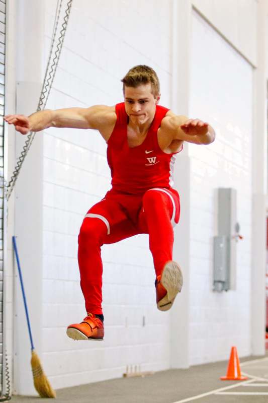 a man in red uniform jumping in the air