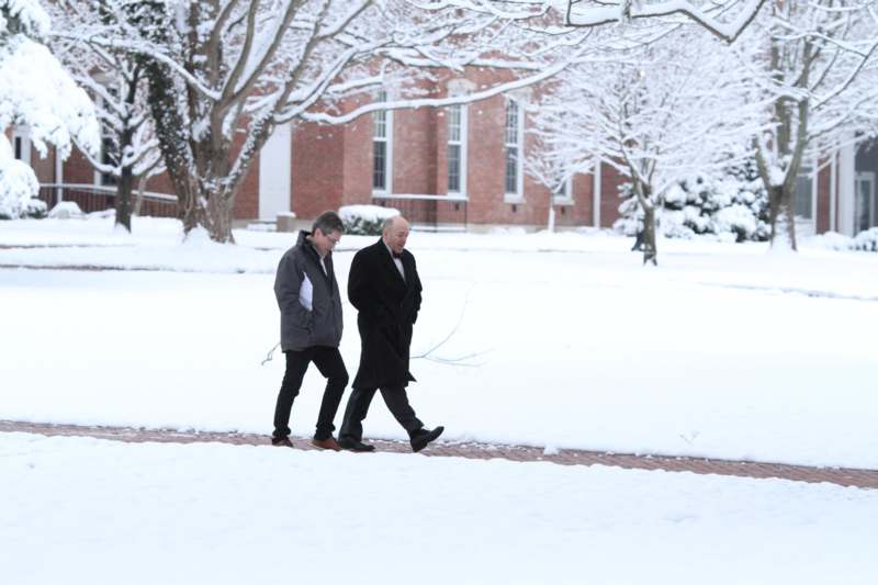 two men walking in the snow