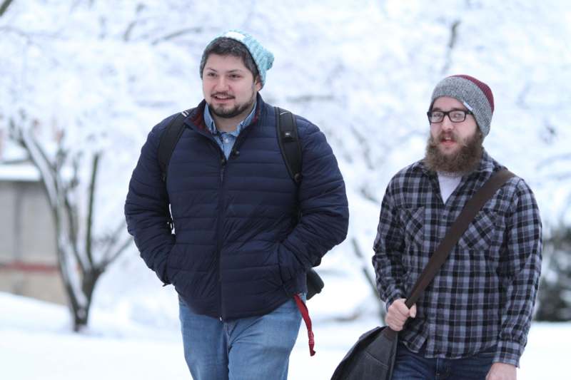 two men walking in the snow