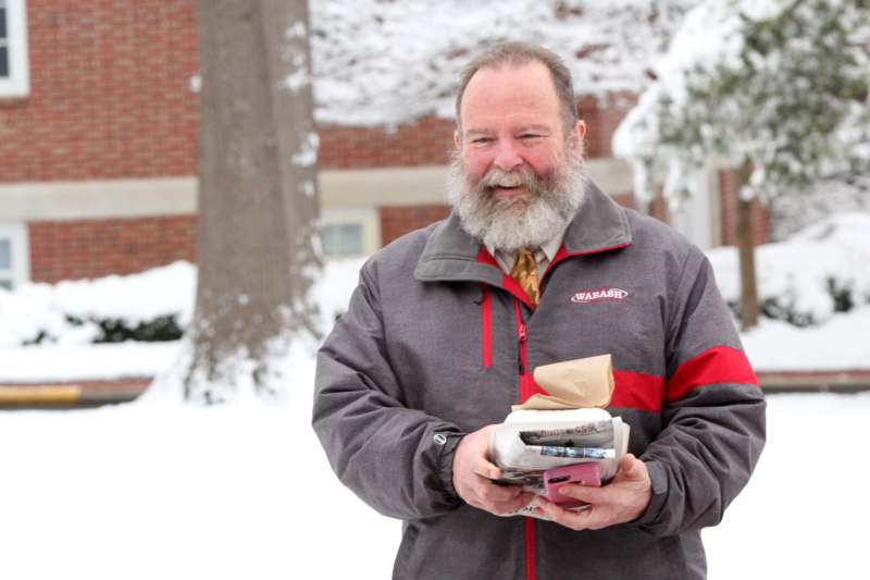 a man holding a package in the snow