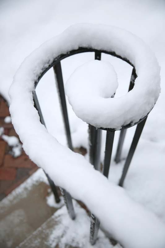 a snow on a railing