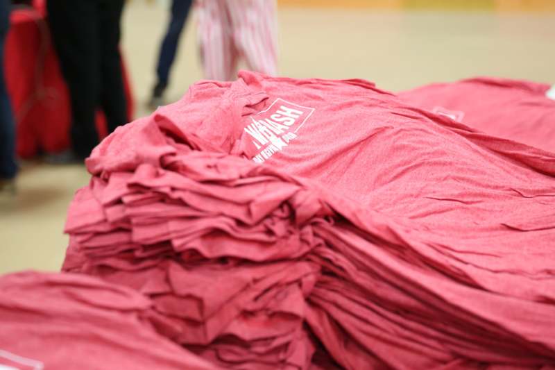 a pile of red t-shirts