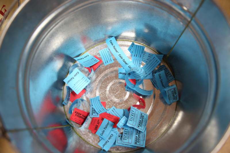 a bucket full of blue and red tags
