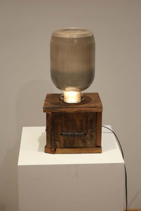 a glass jar on a wooden box
