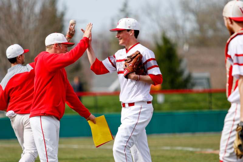 a baseball players giving each other a high five