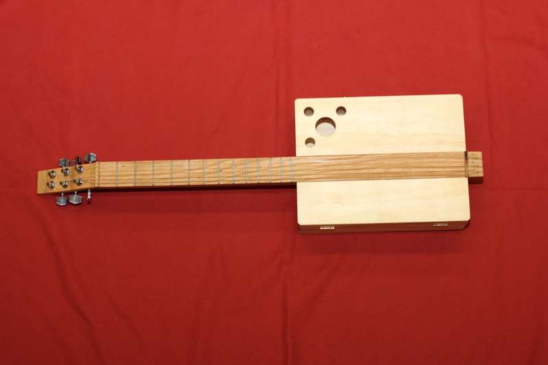 a wooden cigar box with a guitar