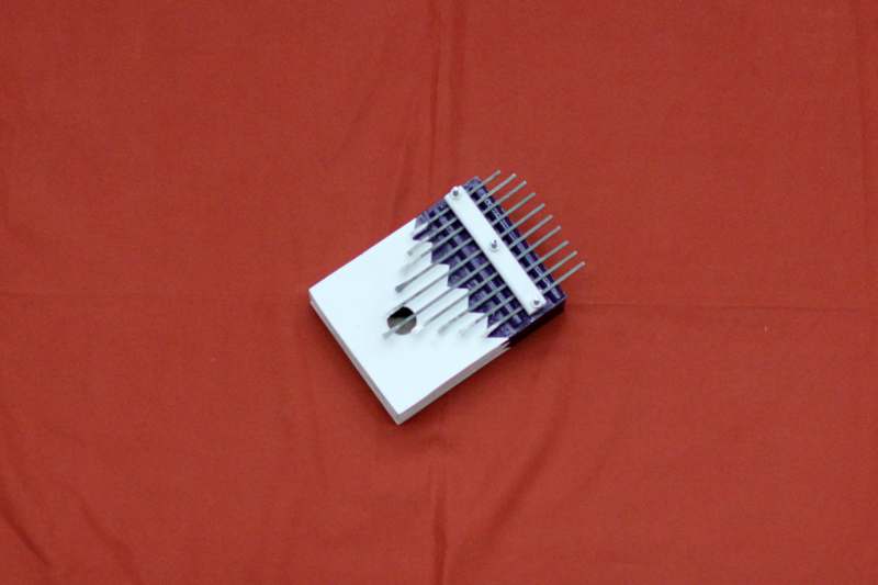 a small white box with metal rods on it