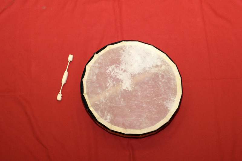 a drum on a red surface
