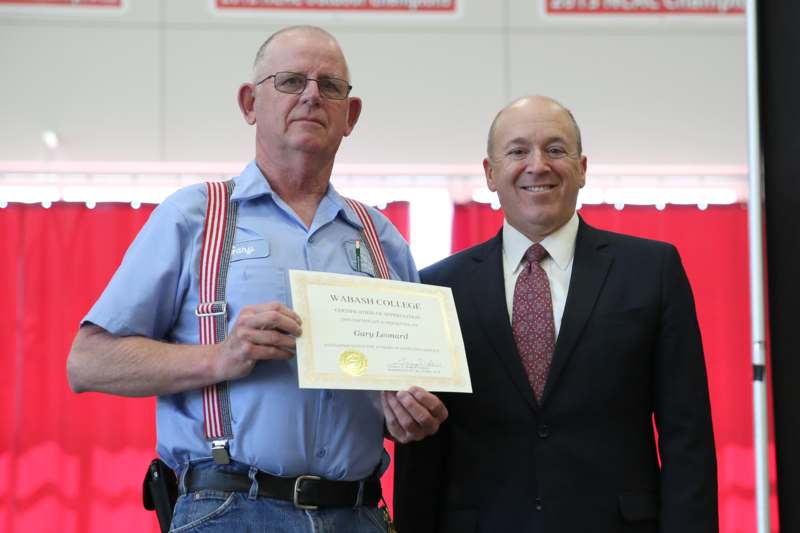 a man holding a certificate