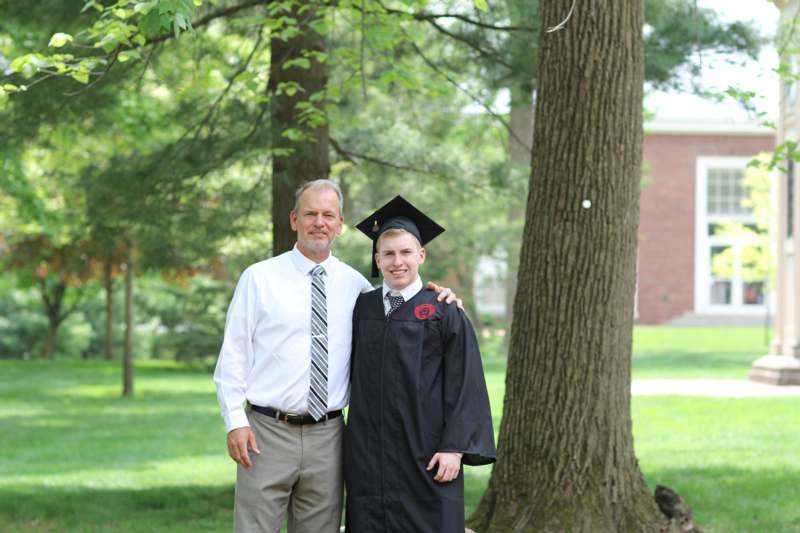 a man and boy in graduation gowns