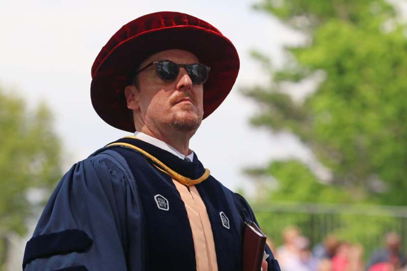 a man wearing a robe and sunglasses