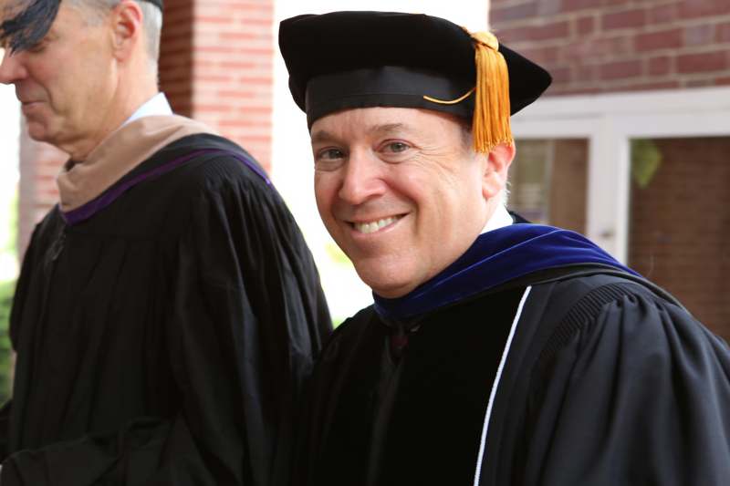 a man wearing a graduation cap and gown