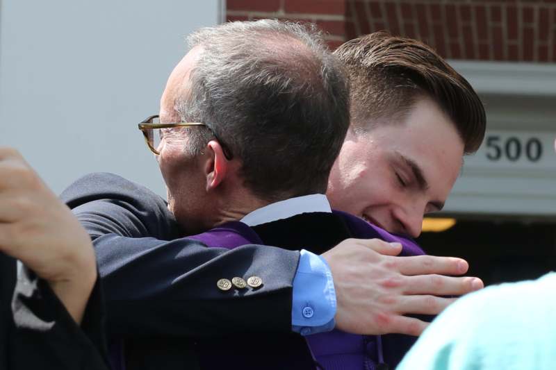 a man hugging another man