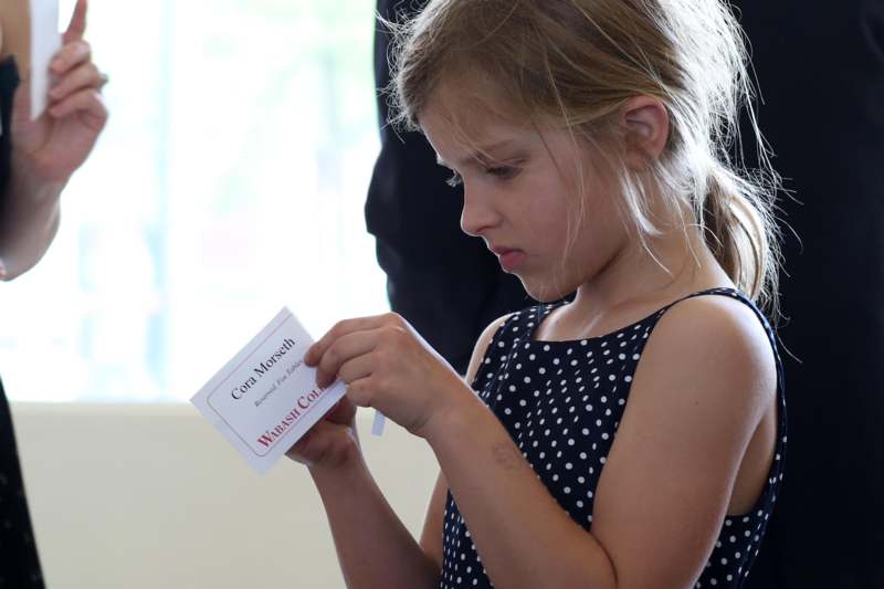 a girl holding a card