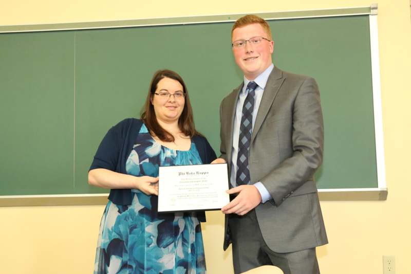 a man and woman holding a certificate