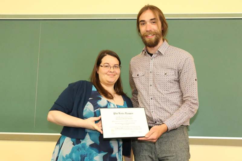 a man and woman holding a certificate
