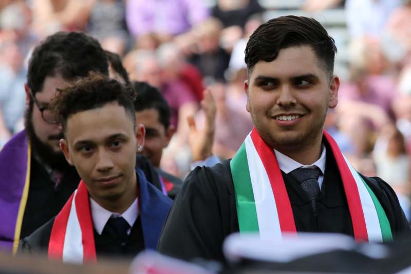 a group of men wearing graduation caps and ties