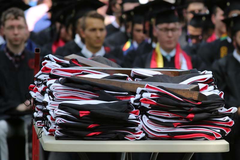 a stack of graduation caps on a table