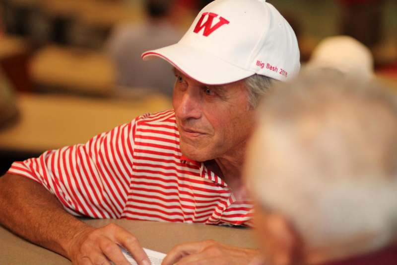 a man wearing a white hat and red striped shirt