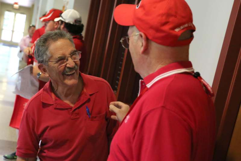 a man in red shirt and hat laughing