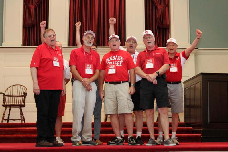 a group of men wearing matching red shirts