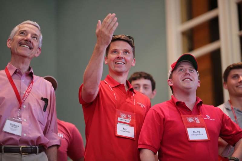 a group of men wearing red shirts and matching name tags