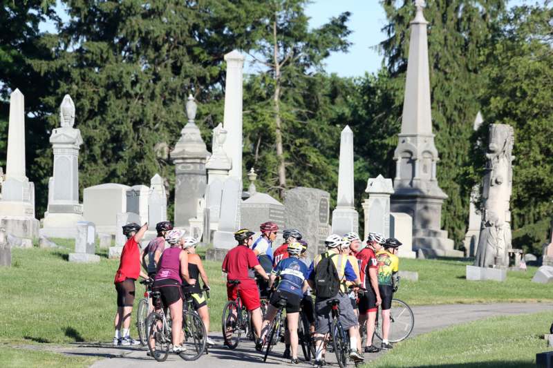 a group of people on bicycles in a cemetery