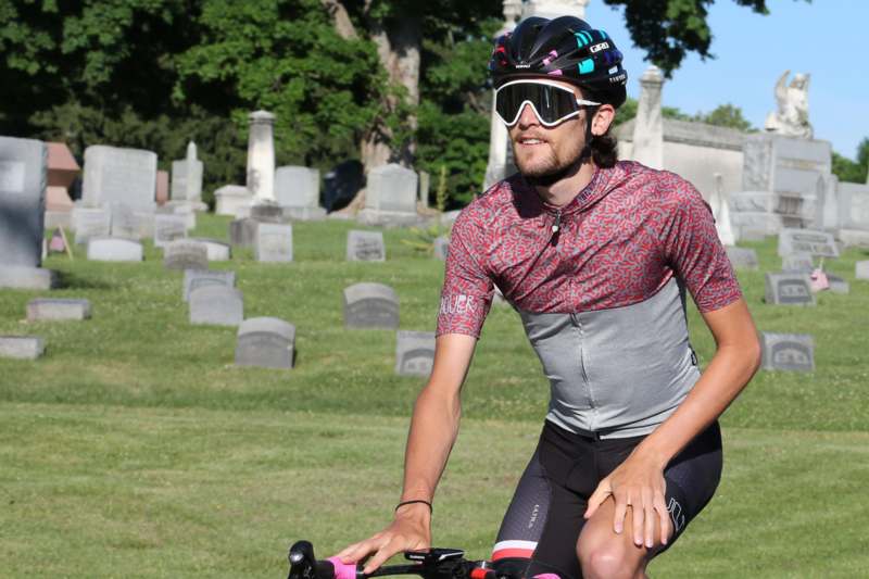 a man riding a bicycle in a cemetery