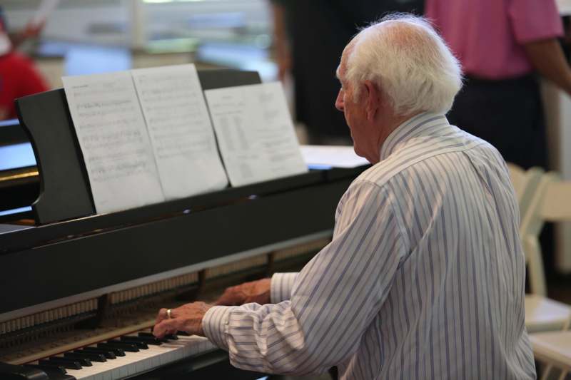 an old man playing piano
