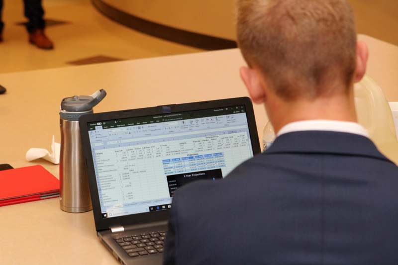 a man in a suit using a laptop