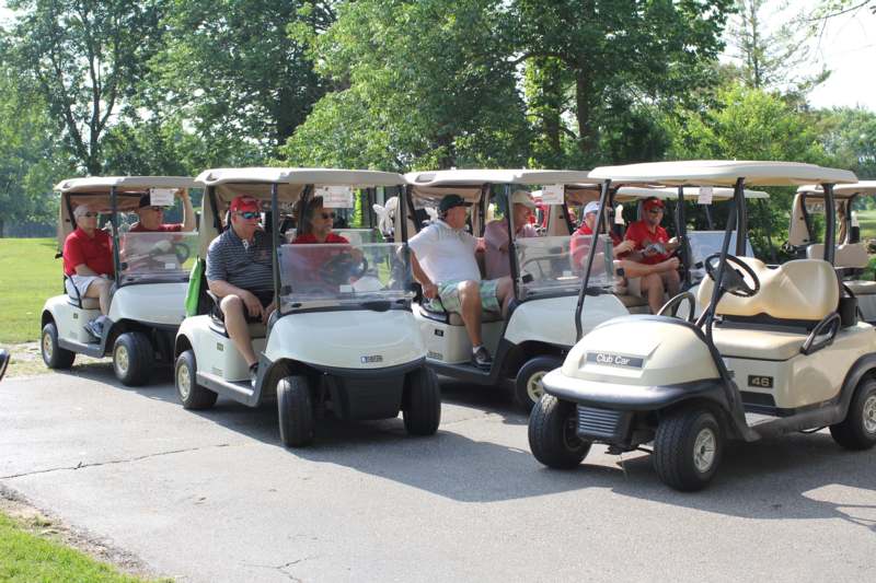 a group of people in golf carts