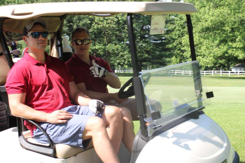 two men in a golf cart