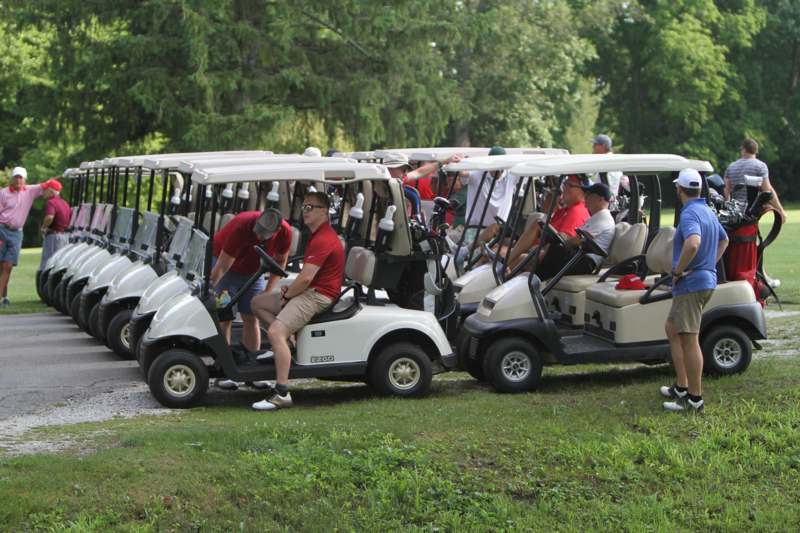 a group of people in golf carts