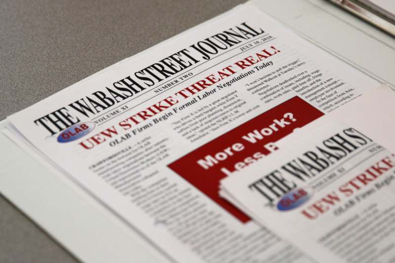 a newspaper with red and white text