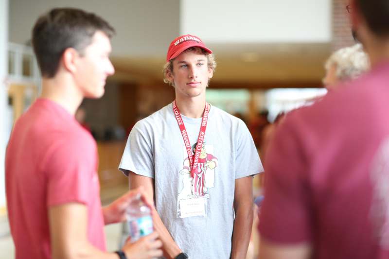 a man wearing a red hat and lanyard