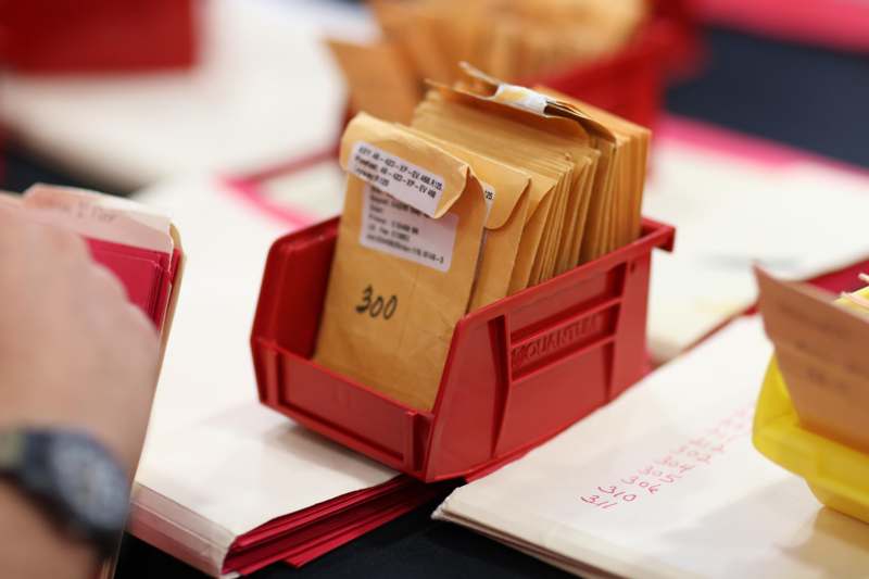 a red container with brown envelopes in it