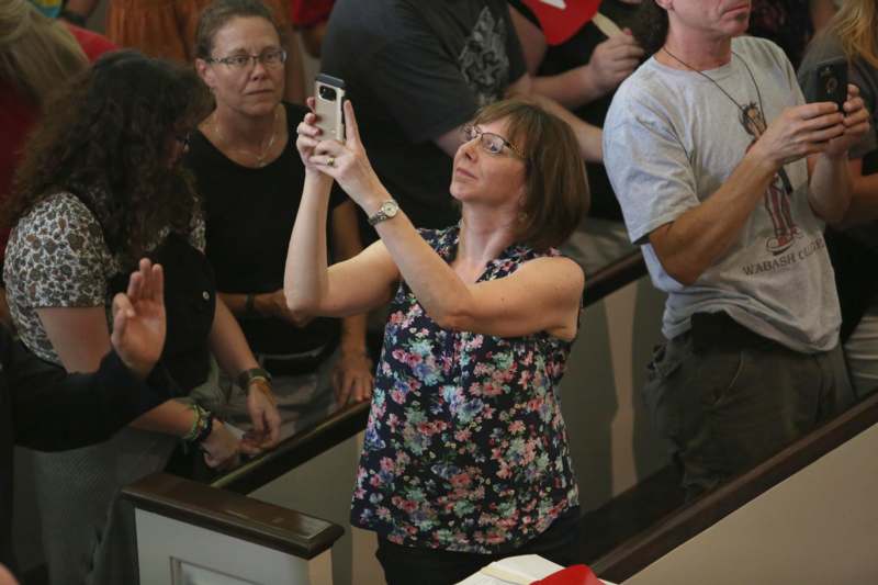 a woman taking a selfie with a group of people