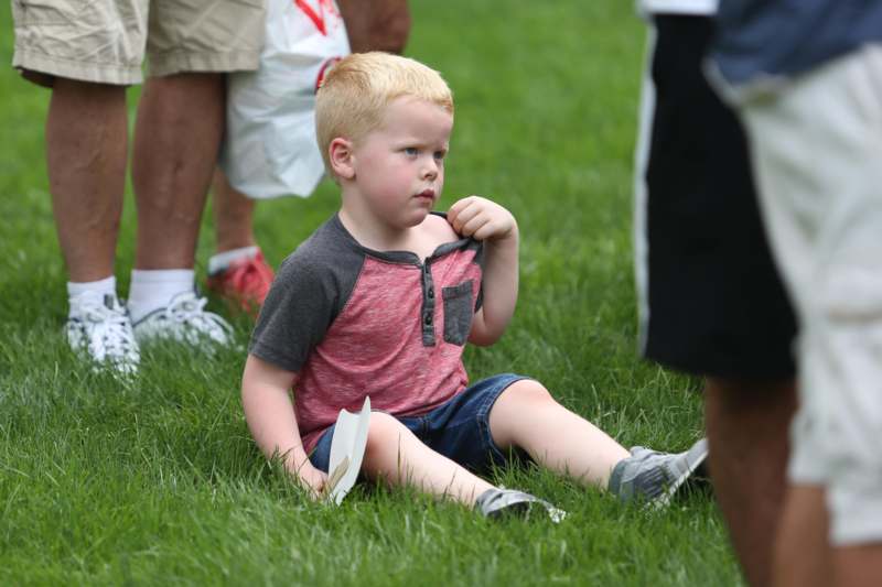 a boy sitting on the grass