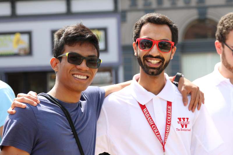 two men wearing sunglasses and smiling