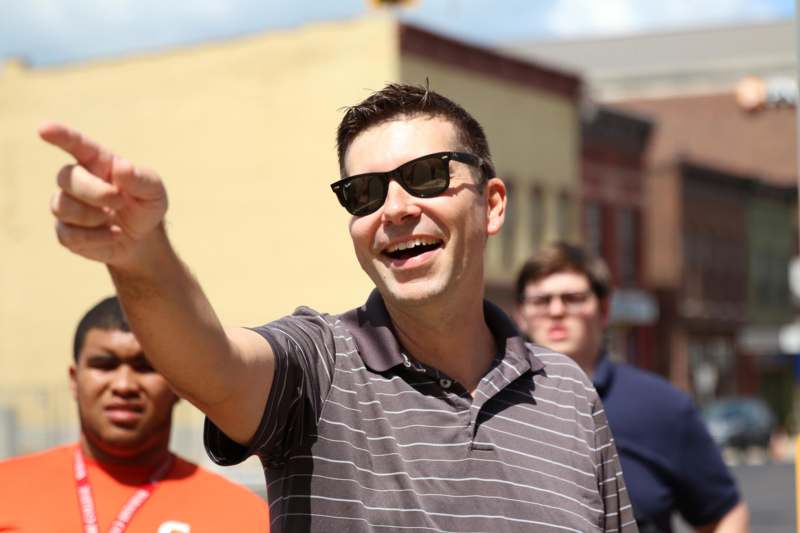 a man in sunglasses pointing his finger