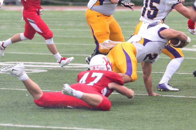 a football player falling down on the ground