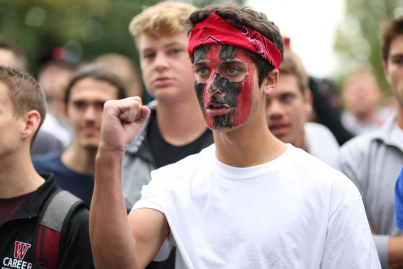 a man with a red bandana and black face paint
